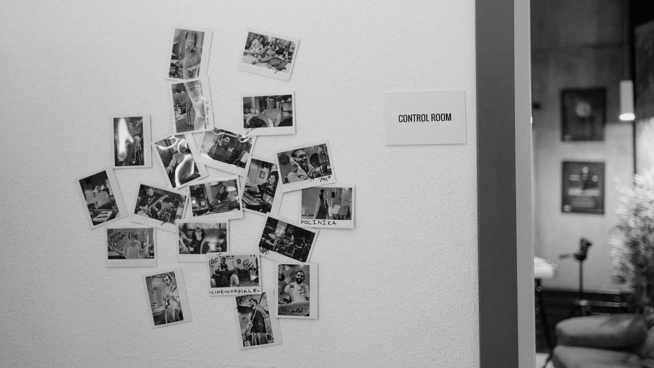 Wall decorated with signed client photos near the entrance to the control room at Sound Pressure Studios.